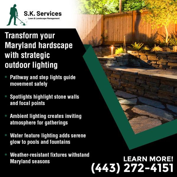 Nighttime view of a multi-tiered, dry-stacked stone retaining wall illuminated by strategic pathway lights and spotlights. Lighting benefits: